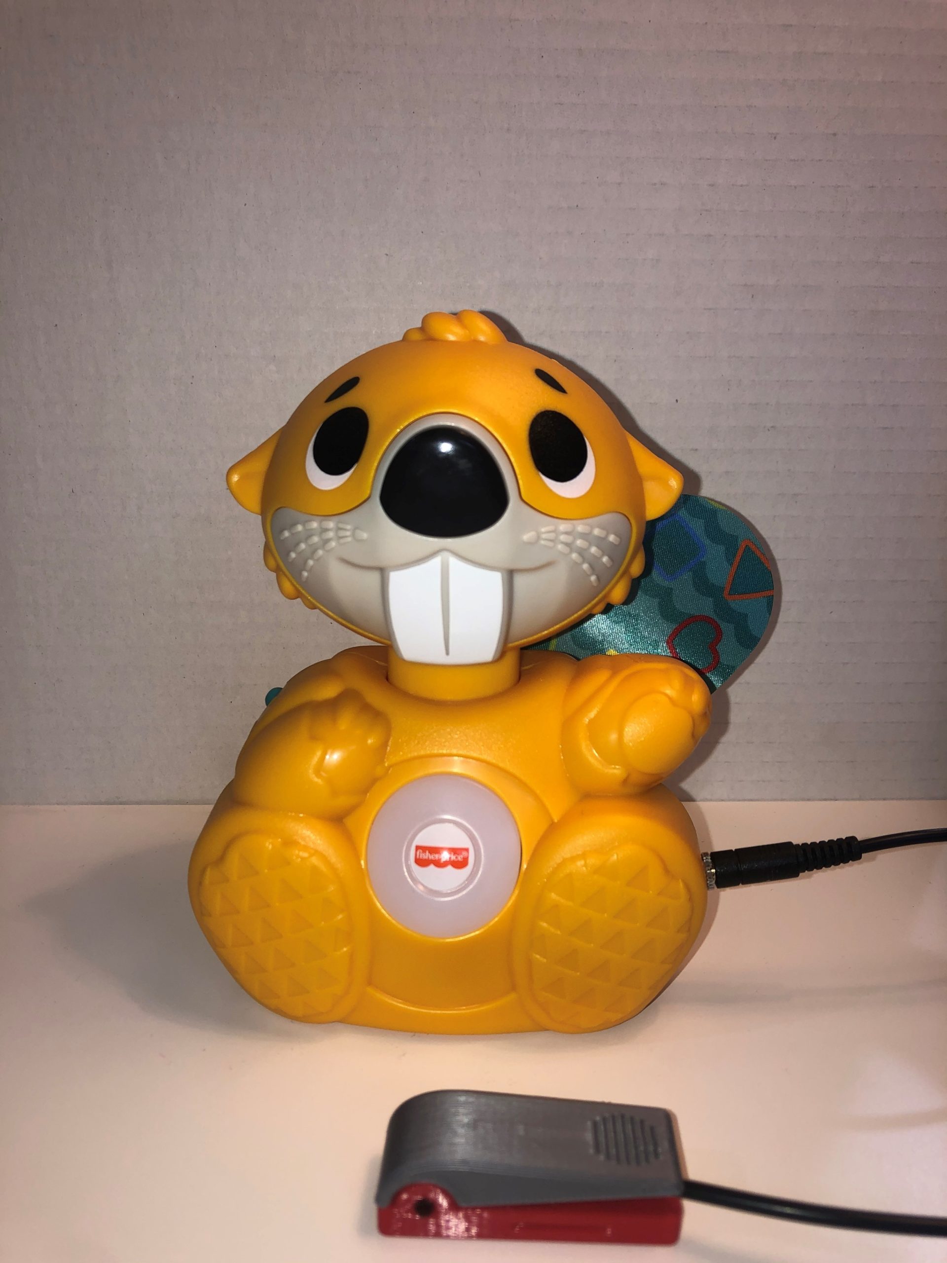 A switch adapted yellow toy beaver against a white background.