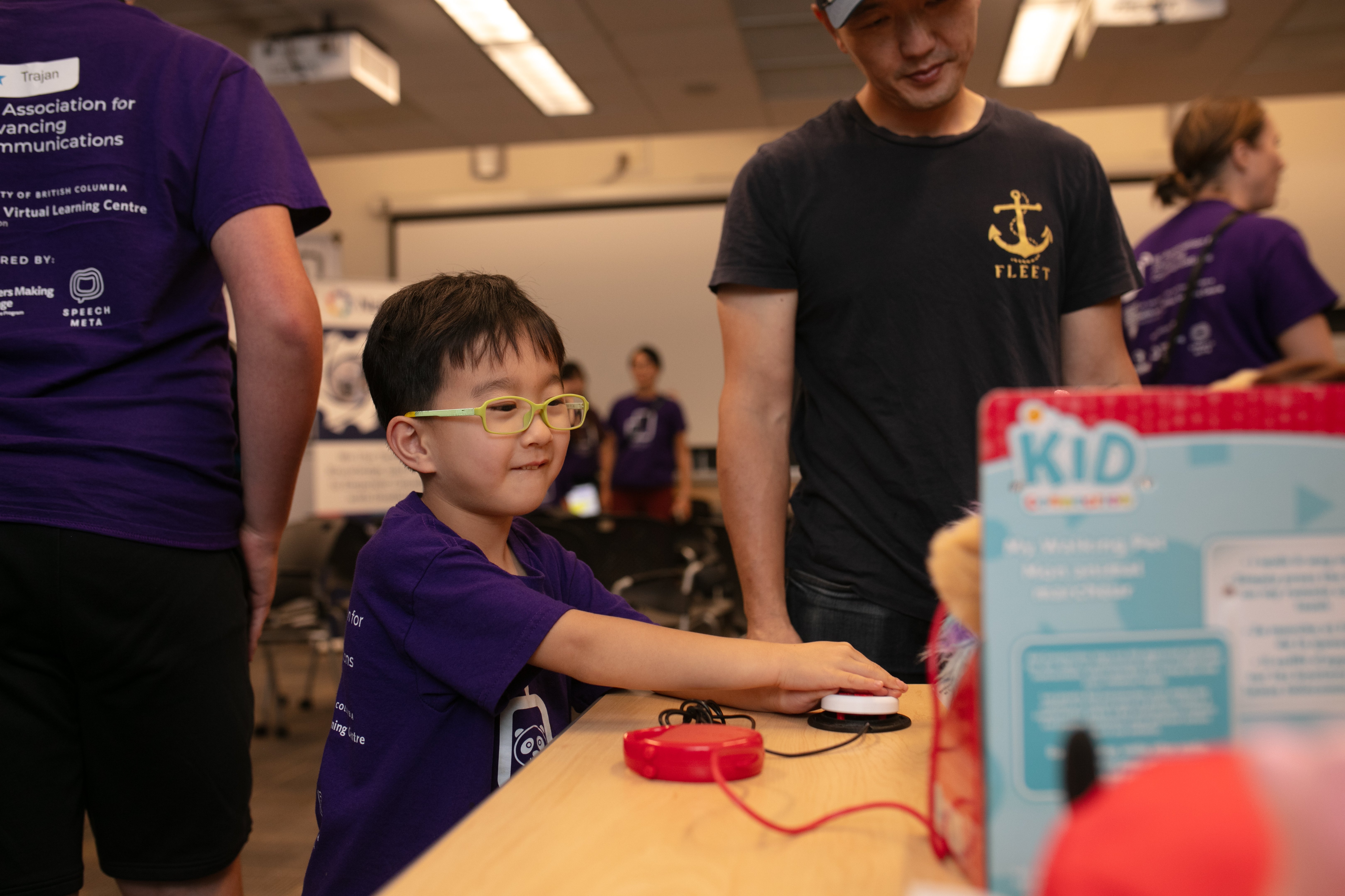 A child using an assistive switch to activate a toy.