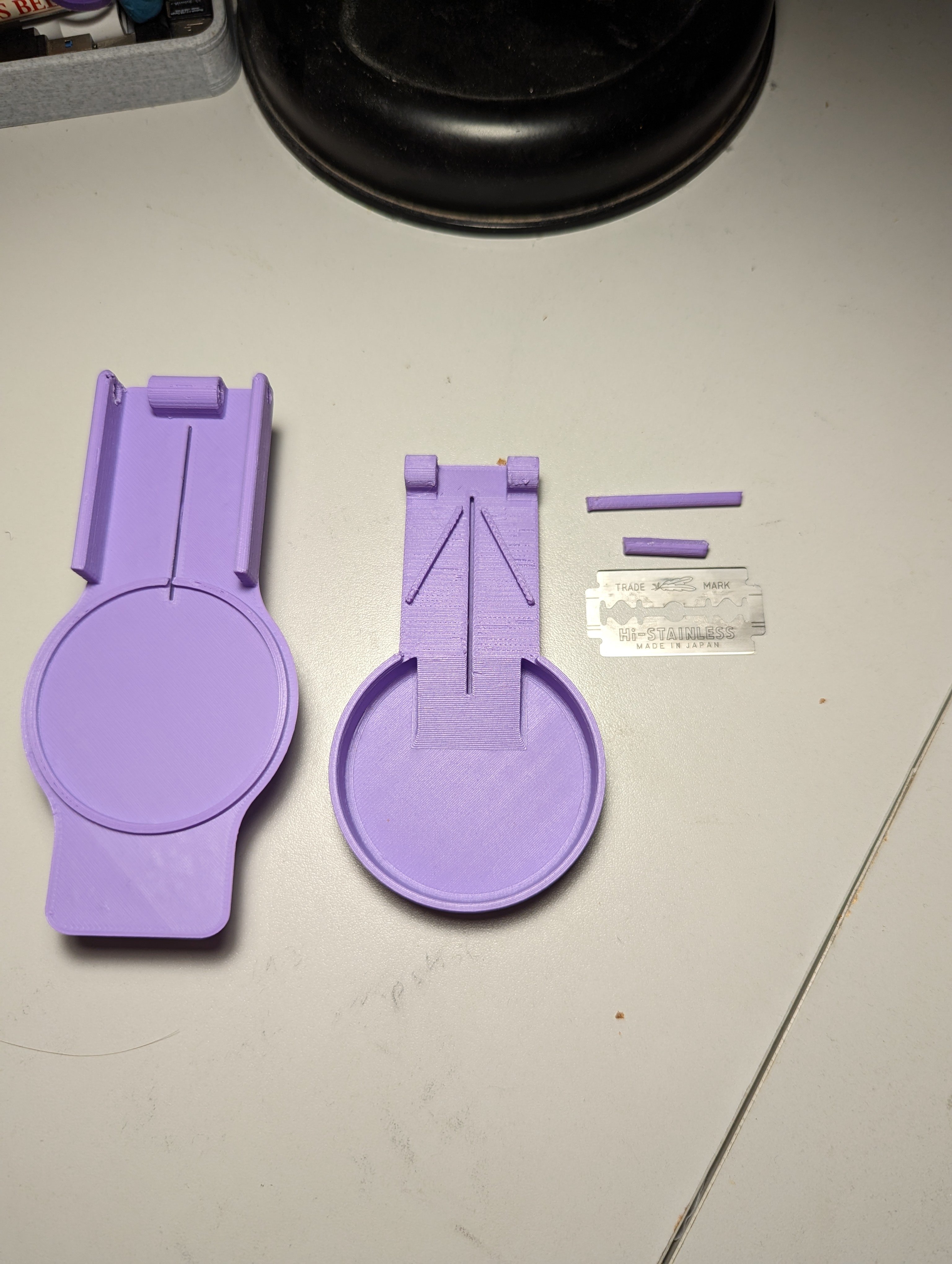 All the components of the pill splitter laid out on a table beside each other