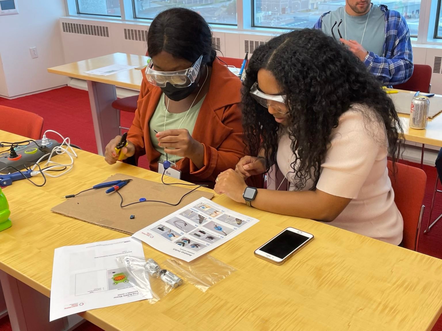 Two volunteers examining device instructions
