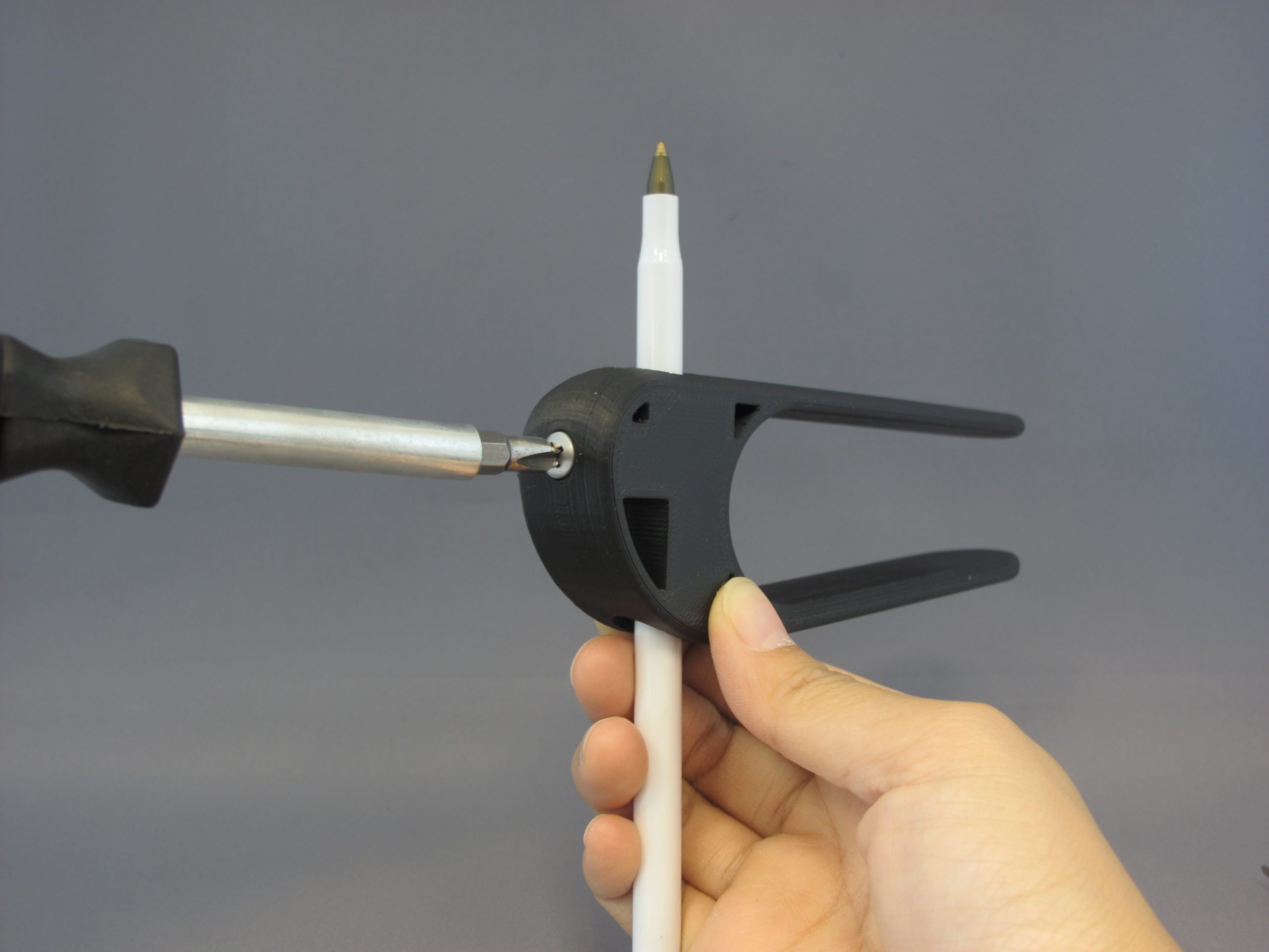 A user using the 3D Printed Palm Pen Holder to draw on a piece of paper with ease
