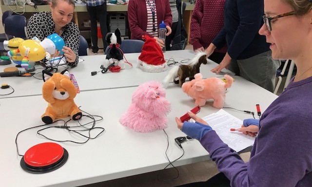 Two volunteers adapting toys.