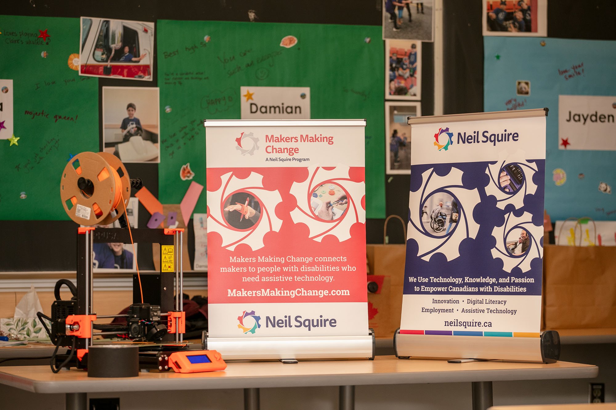 Two table top banners and a 3d printer on a table