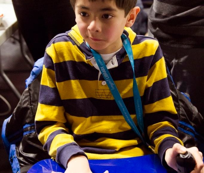 A child using an assistive device.
