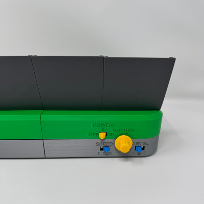 Back labels of the Chatterbox. The Power switch is labeled with "ON" and "OFF", and Volume control is labeled, and the Speed and Level switches are labelled with the numbers 1, 2, and 3.