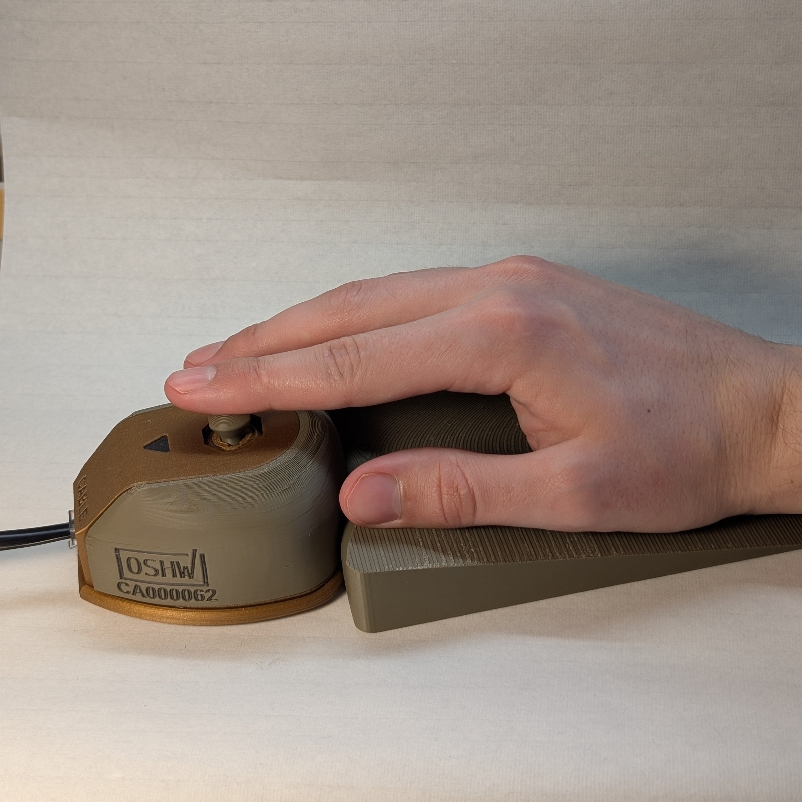 The willow joystick being used with a wrist ramp on a white background.