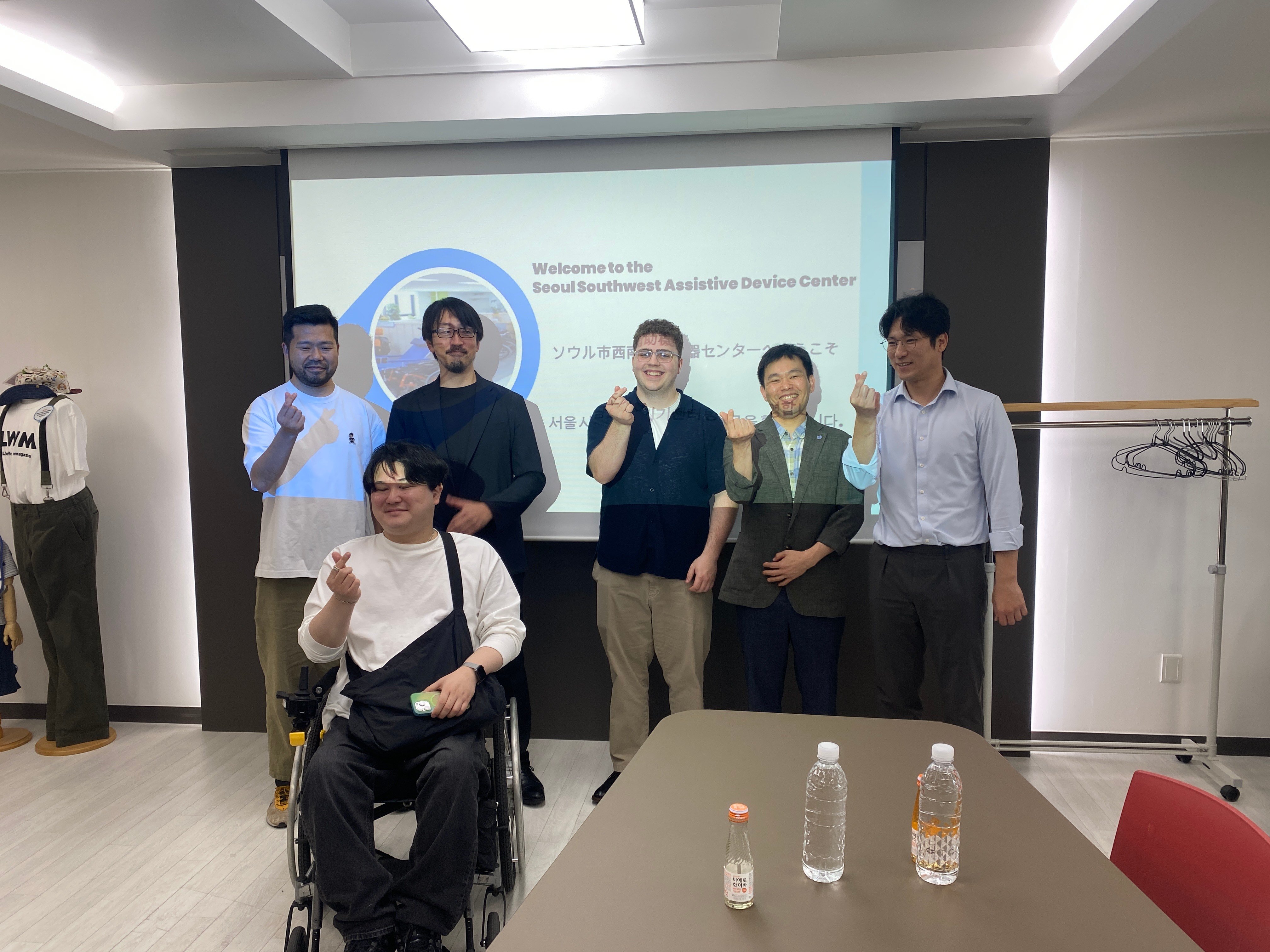 Tyler with delegates at the Seoul Assistive Technology Service Center.
