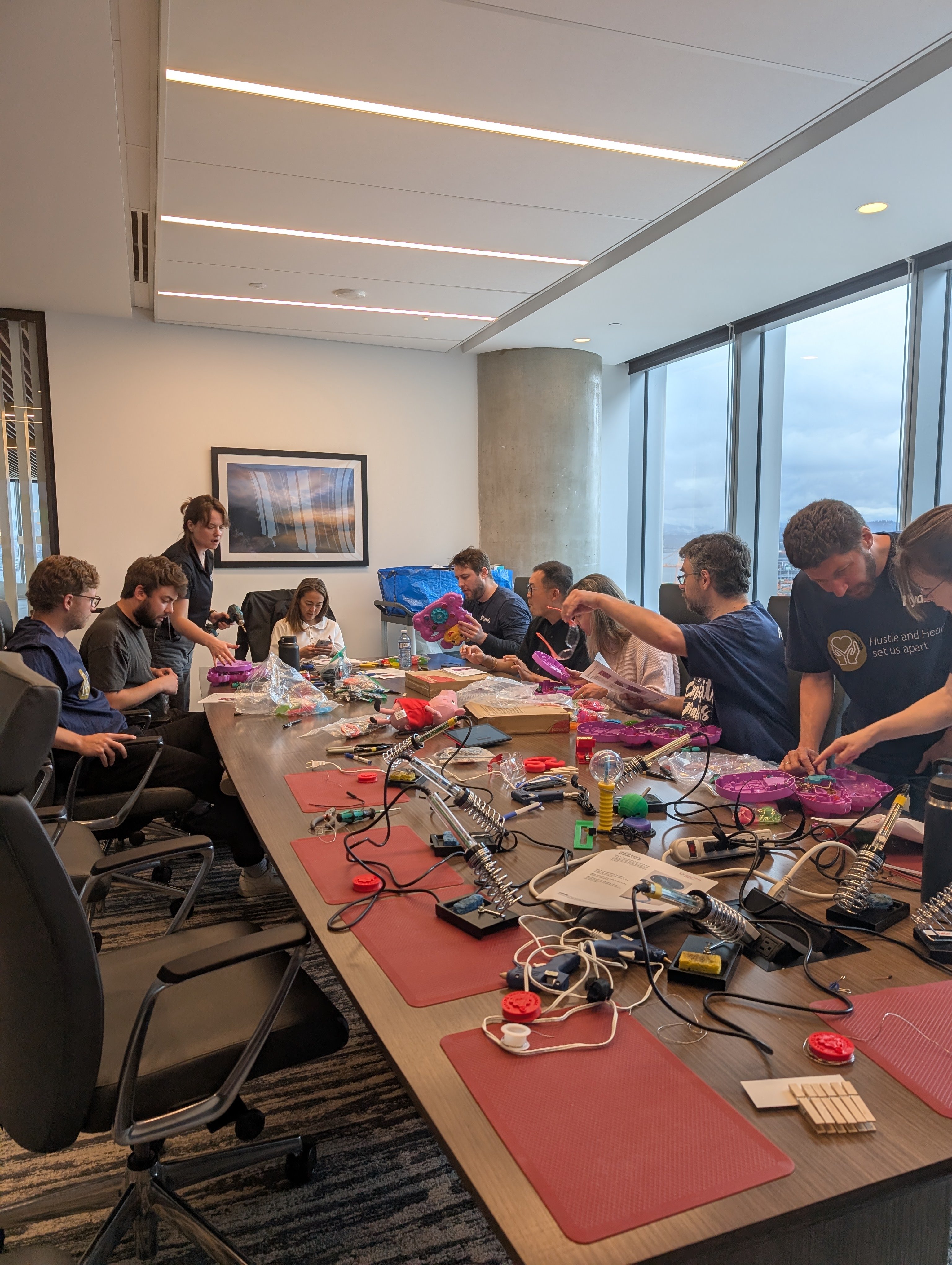 MMC staff member Kris guides a busy room of makers at Ryan's Vancouver office.