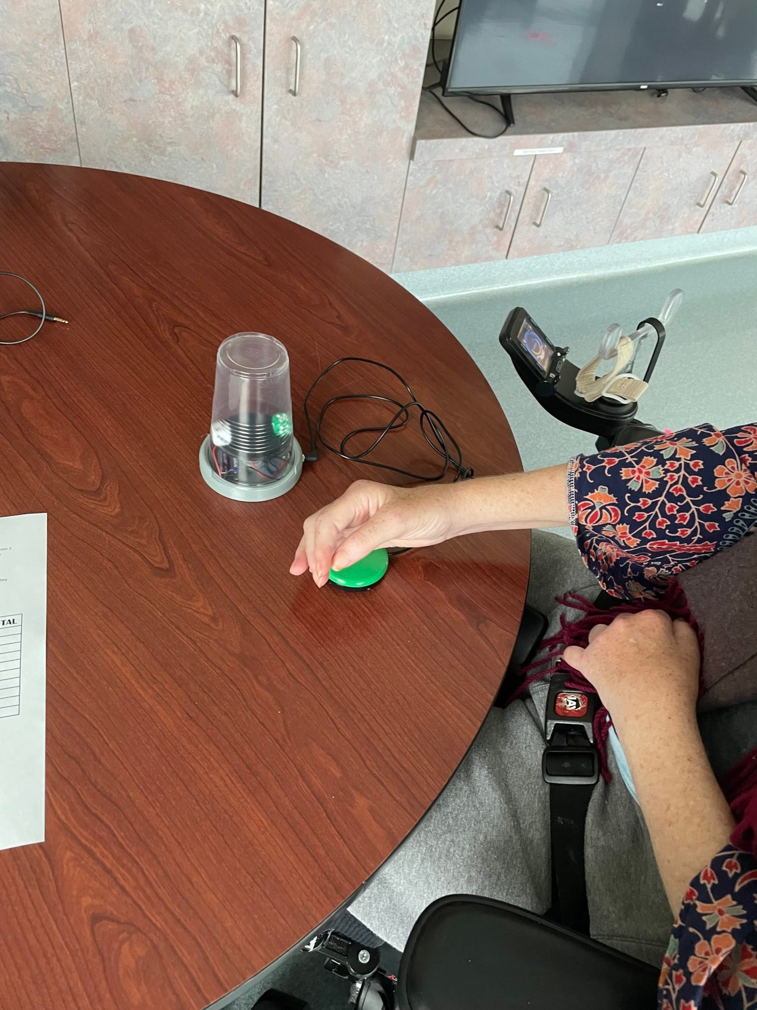 A hand using a switch to activate a Dice Spinner device.