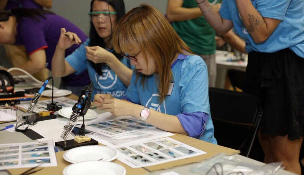 Two EA participants soldering.