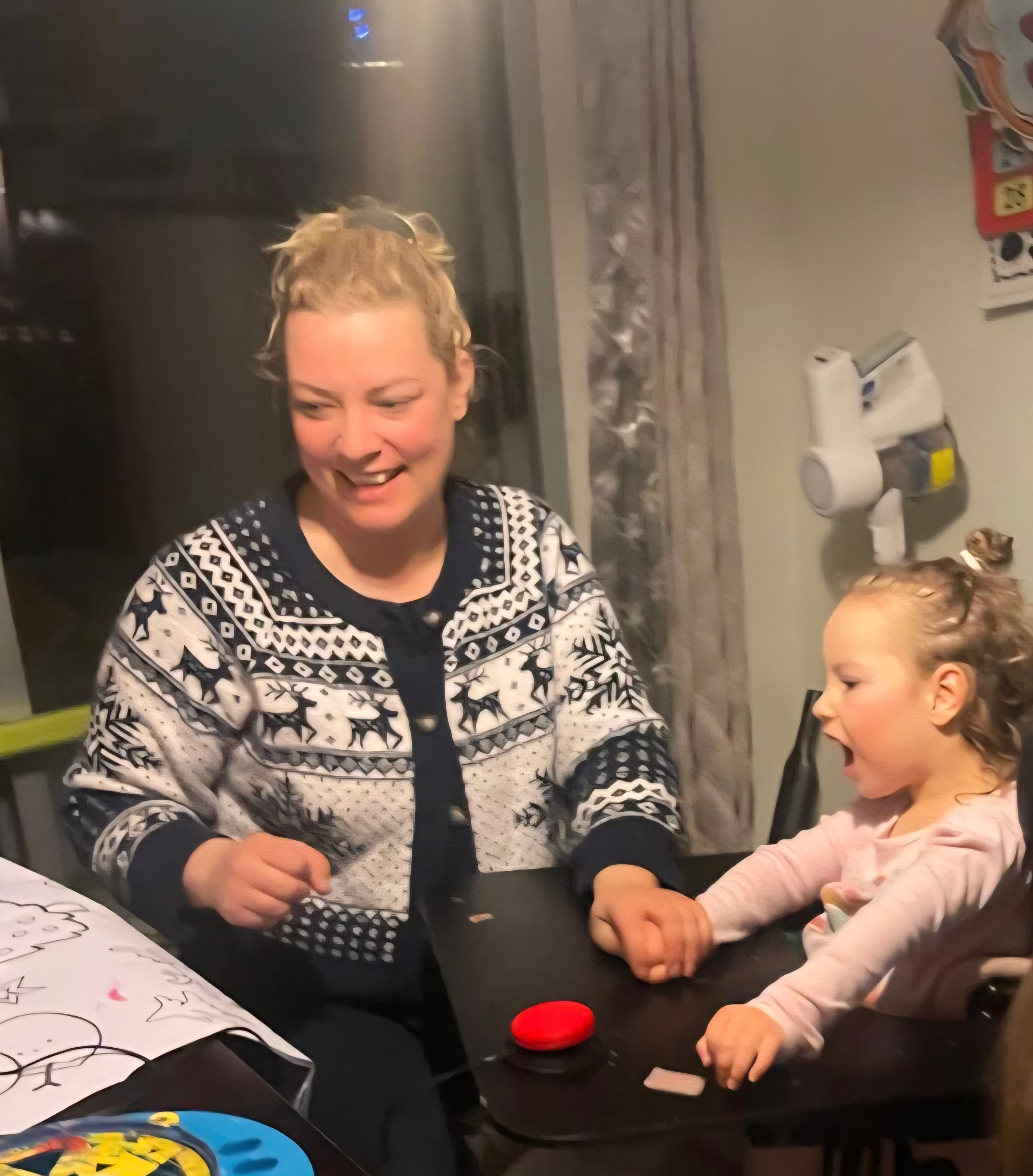 A child and parent playing with a switch-adapted Spinning Art Toy