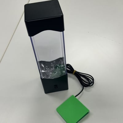 A low profile switch plugged into a tall lava lamp