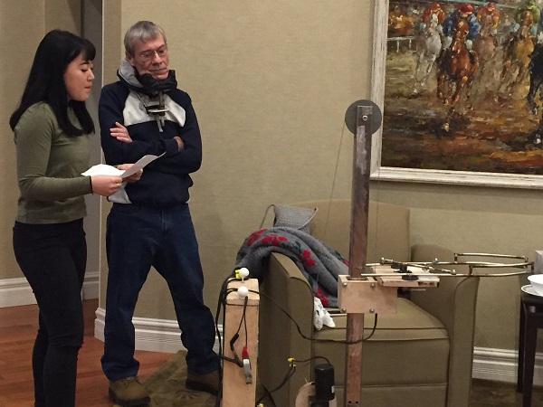 Two makers examining their prototype.