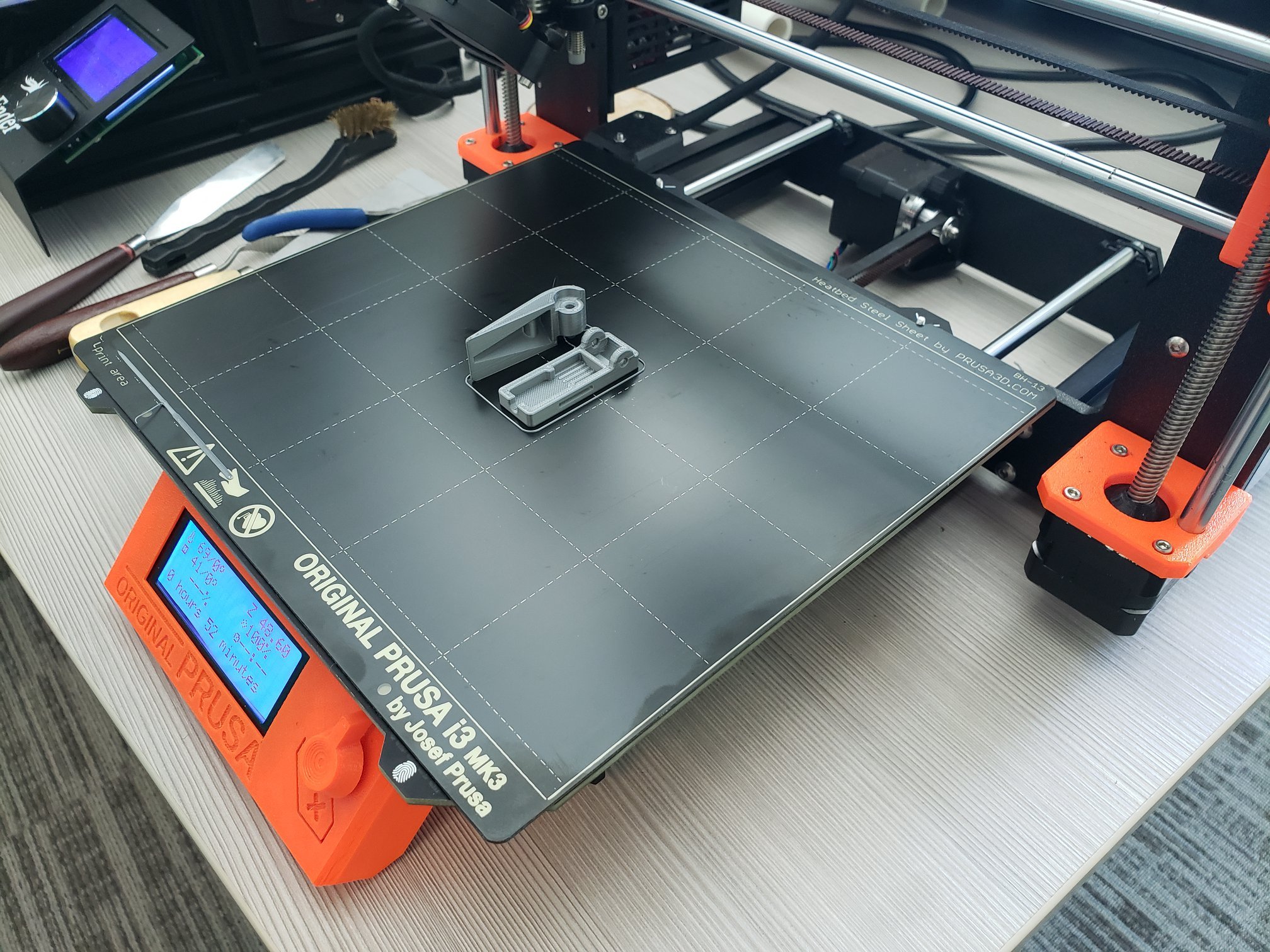 A 3D printer bed with a completed print on it.