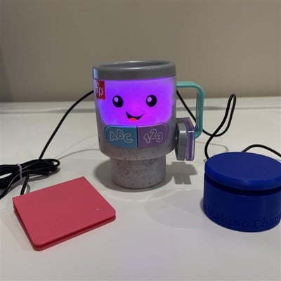 A low profile and MMC60 switch plugged into a toy shaped as a coffee cup with a face