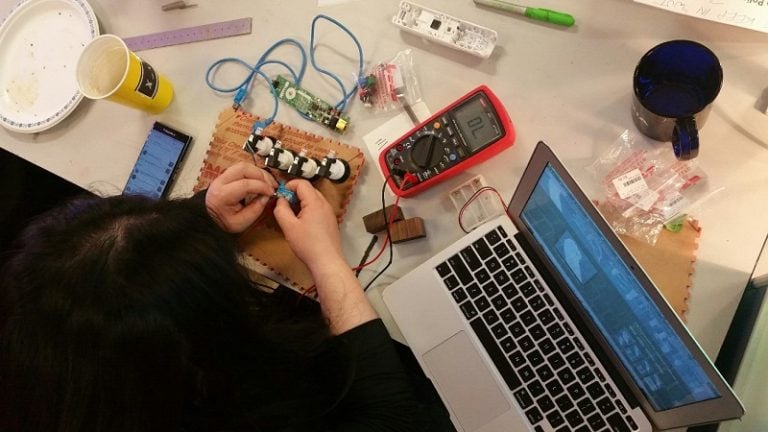 A volunteer working on an accessible Wii controller.