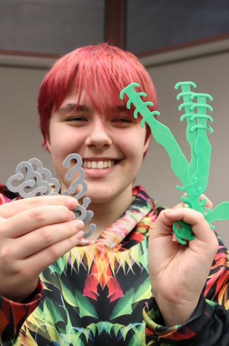 Natasha, MMC volunteer holding 3D printed parts.