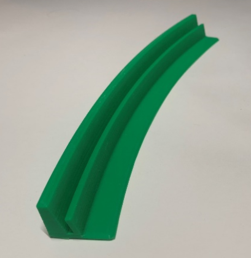 Side view of a green 3D printed single row playing cards holder on a white table.