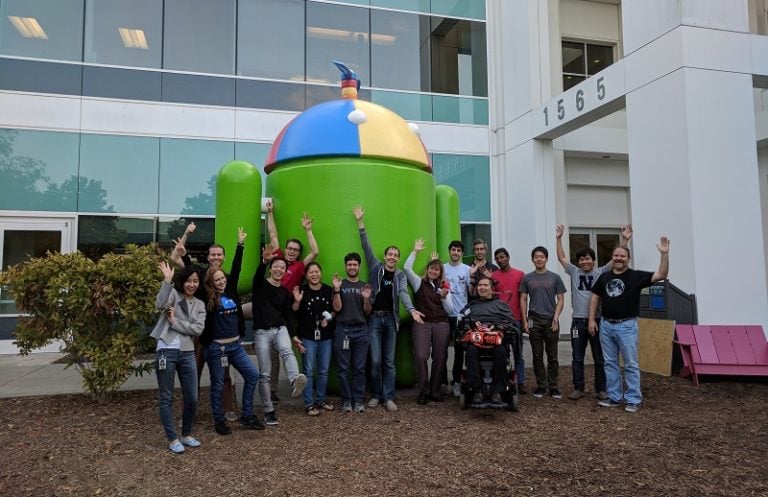 Build participants and MMC staff pictured in front of a large Android structure.