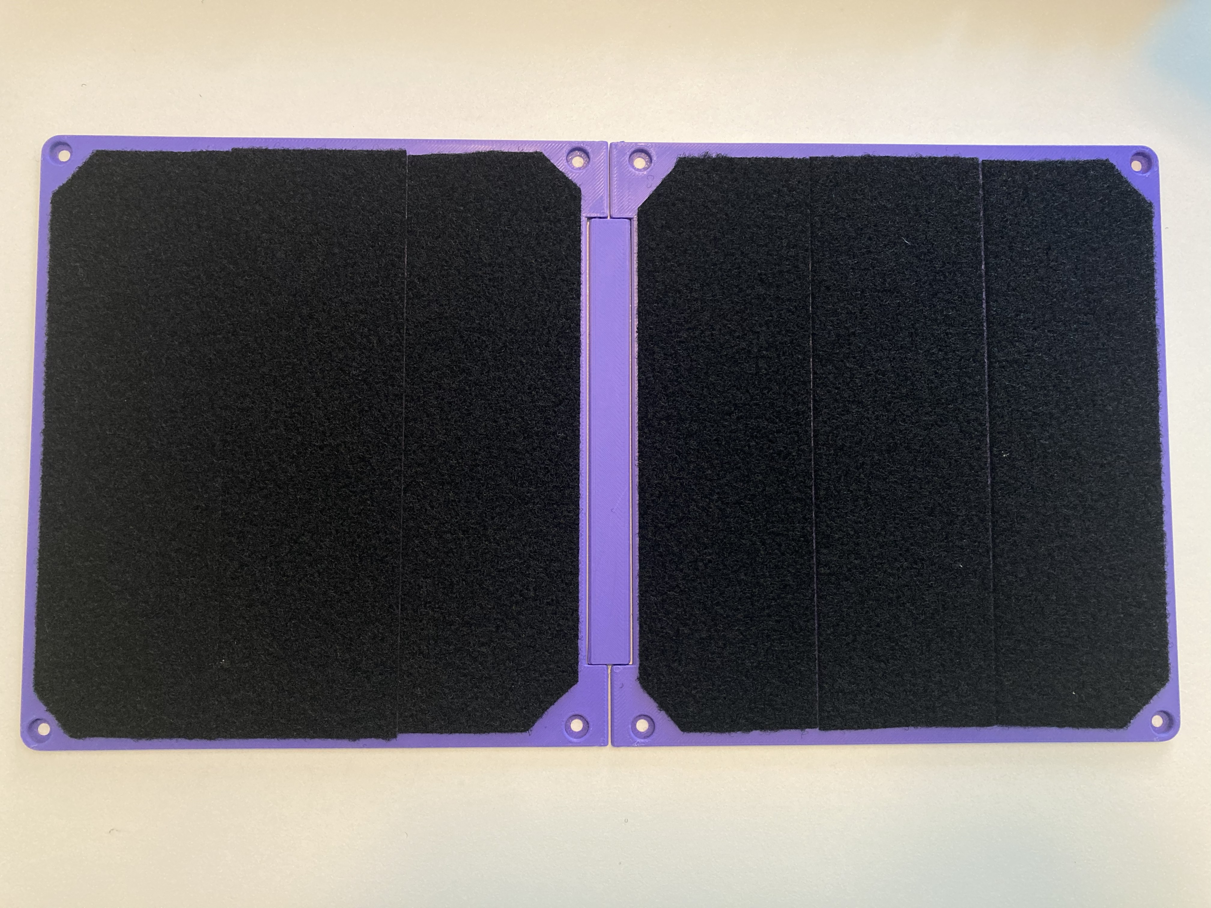 A top down view of the Connect Board Solo, showing the two half boards connected with the hinge. Hook and loop fastener covers each half board.