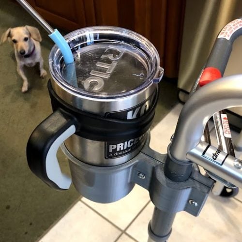 A cup-holder attached to a walking aid.