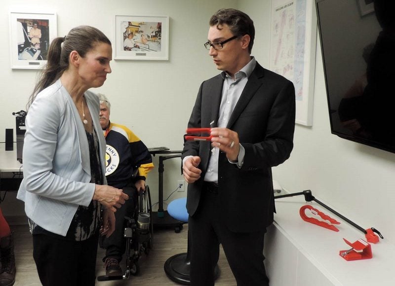 MMC Director of Innovation Chad showing Kirsty Duncan a low tech assistive device.