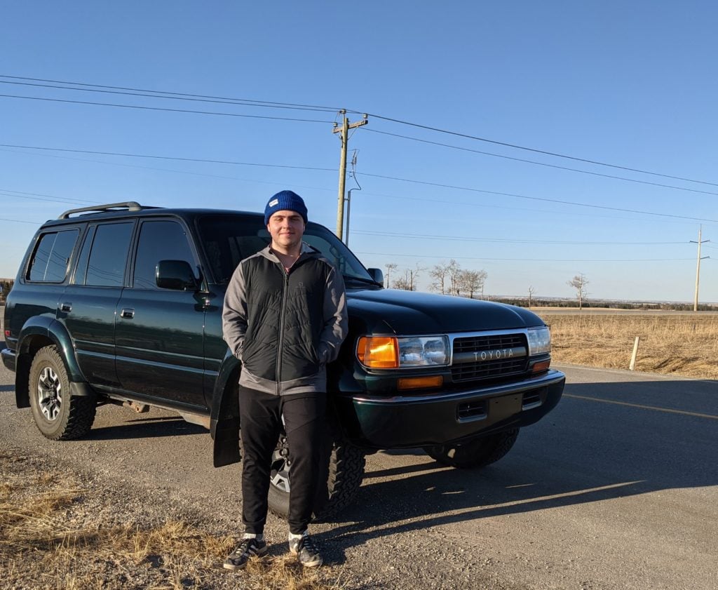 Tyler from MMC standing in front of a car.