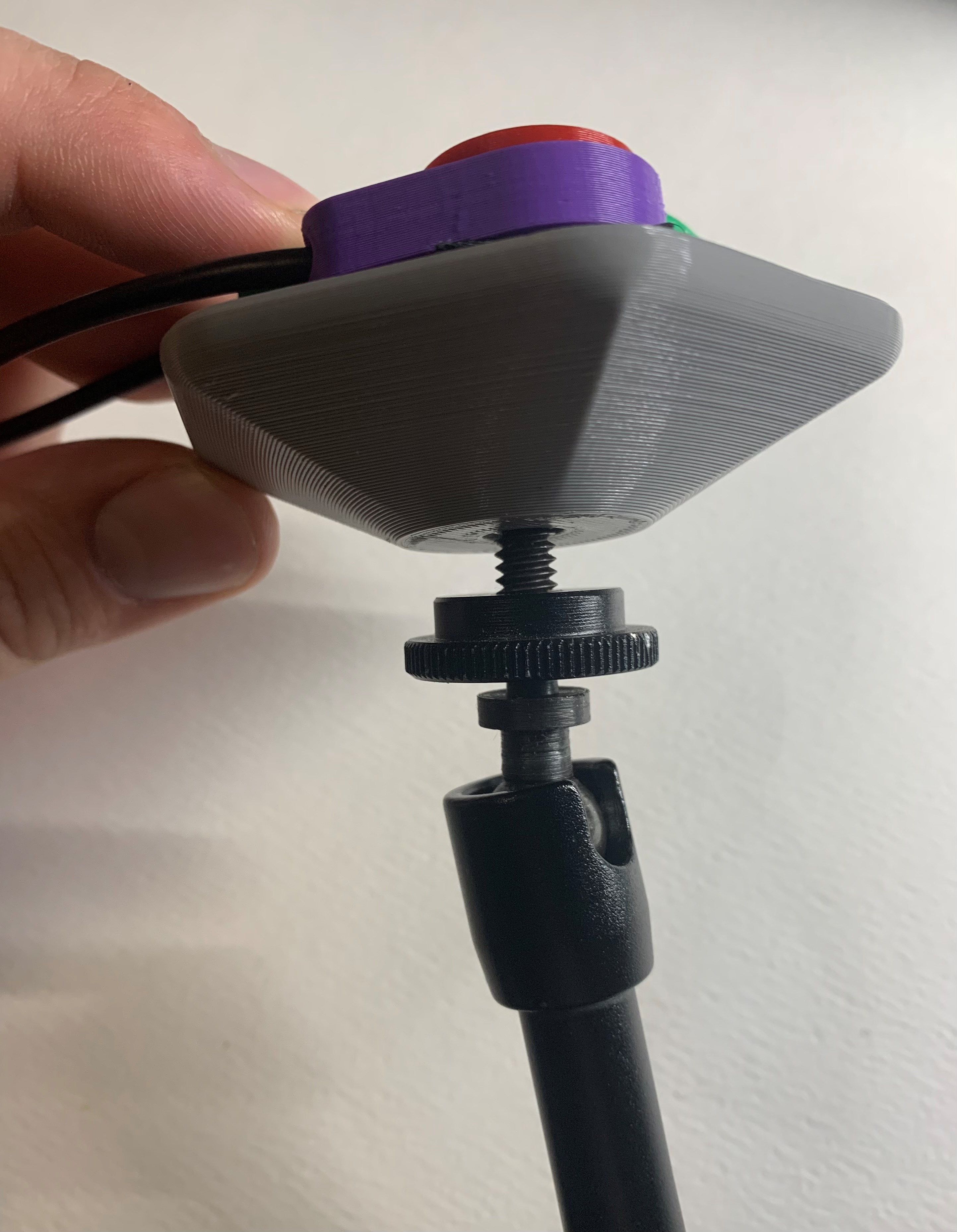 Side view of the Open Universal Mount partially threaded onto a mounting arm