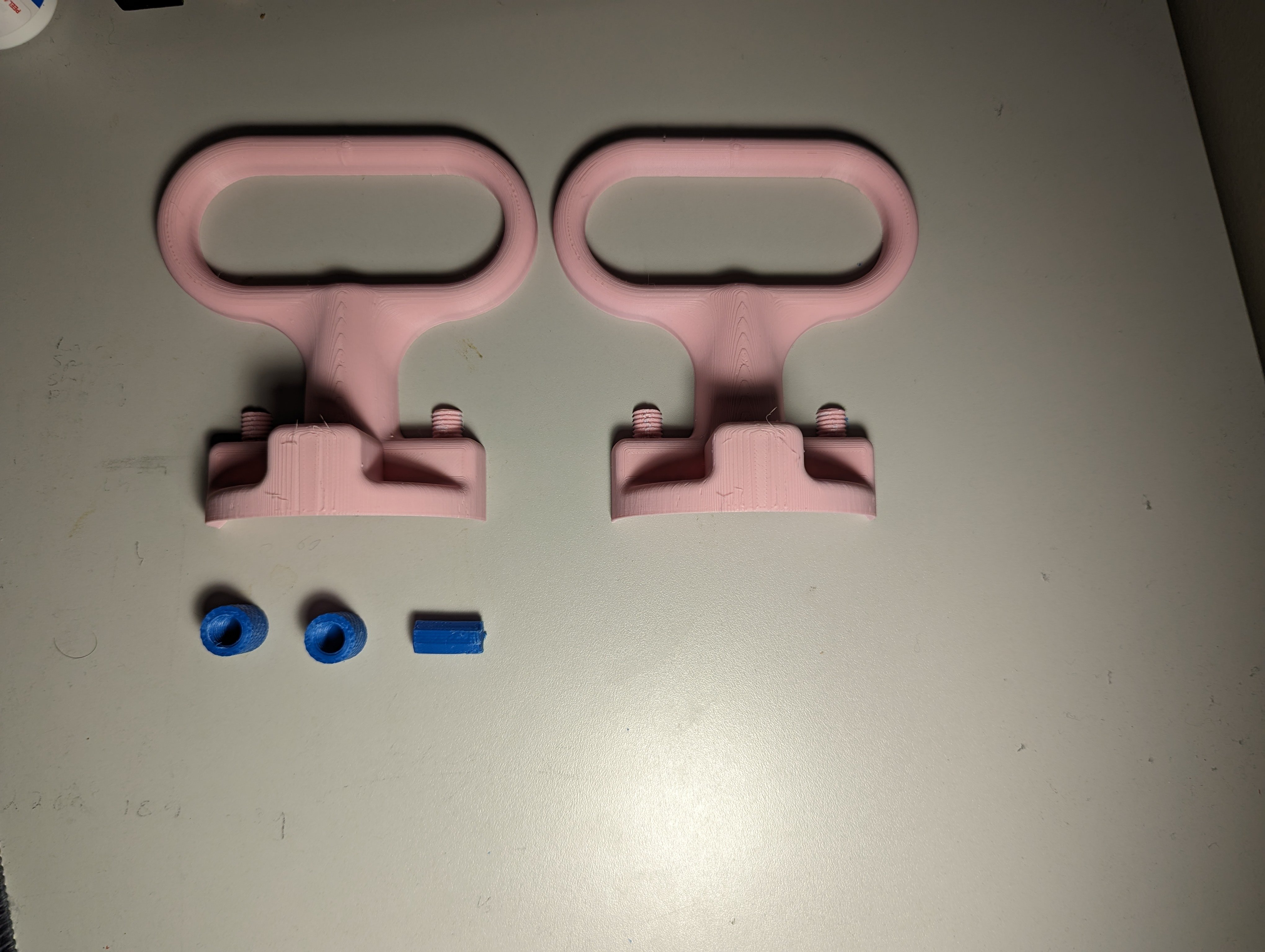 Gas Cap Opener parts unassembled and laid out next to each other on a table
