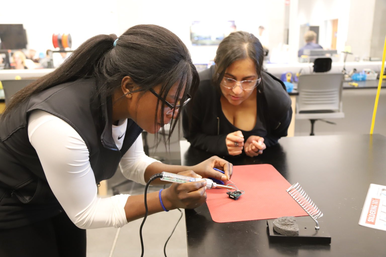 Two Students soldering an MMC60 switch