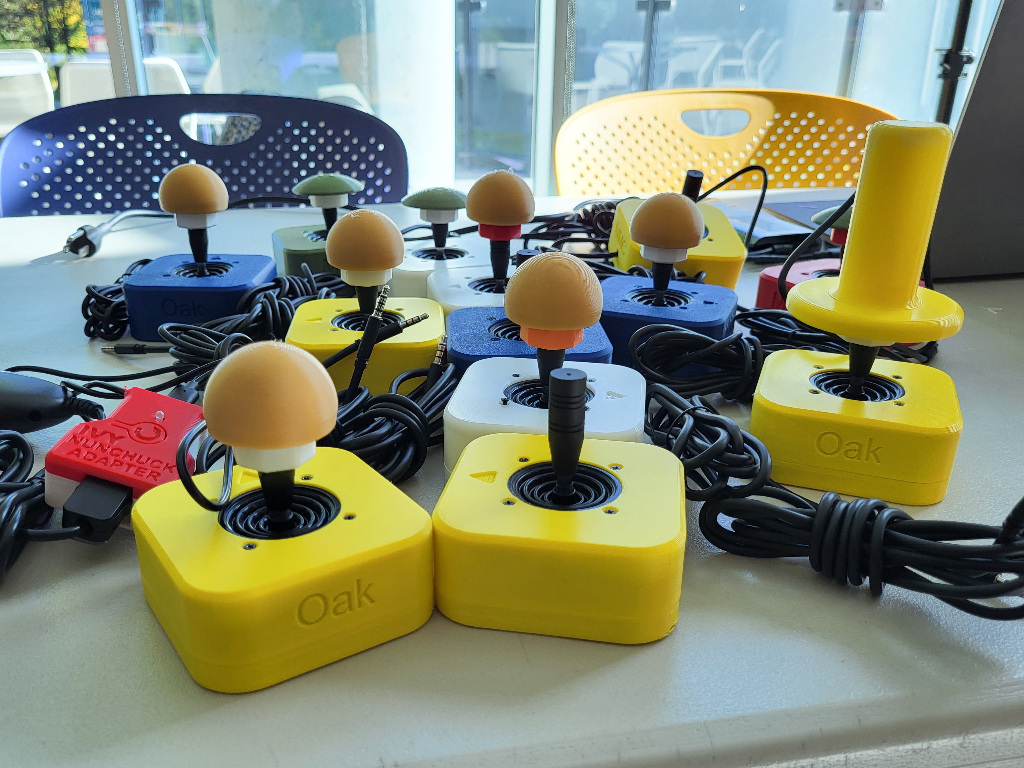 Multiple OpenAT Joysticks from a build event with various different toppers.