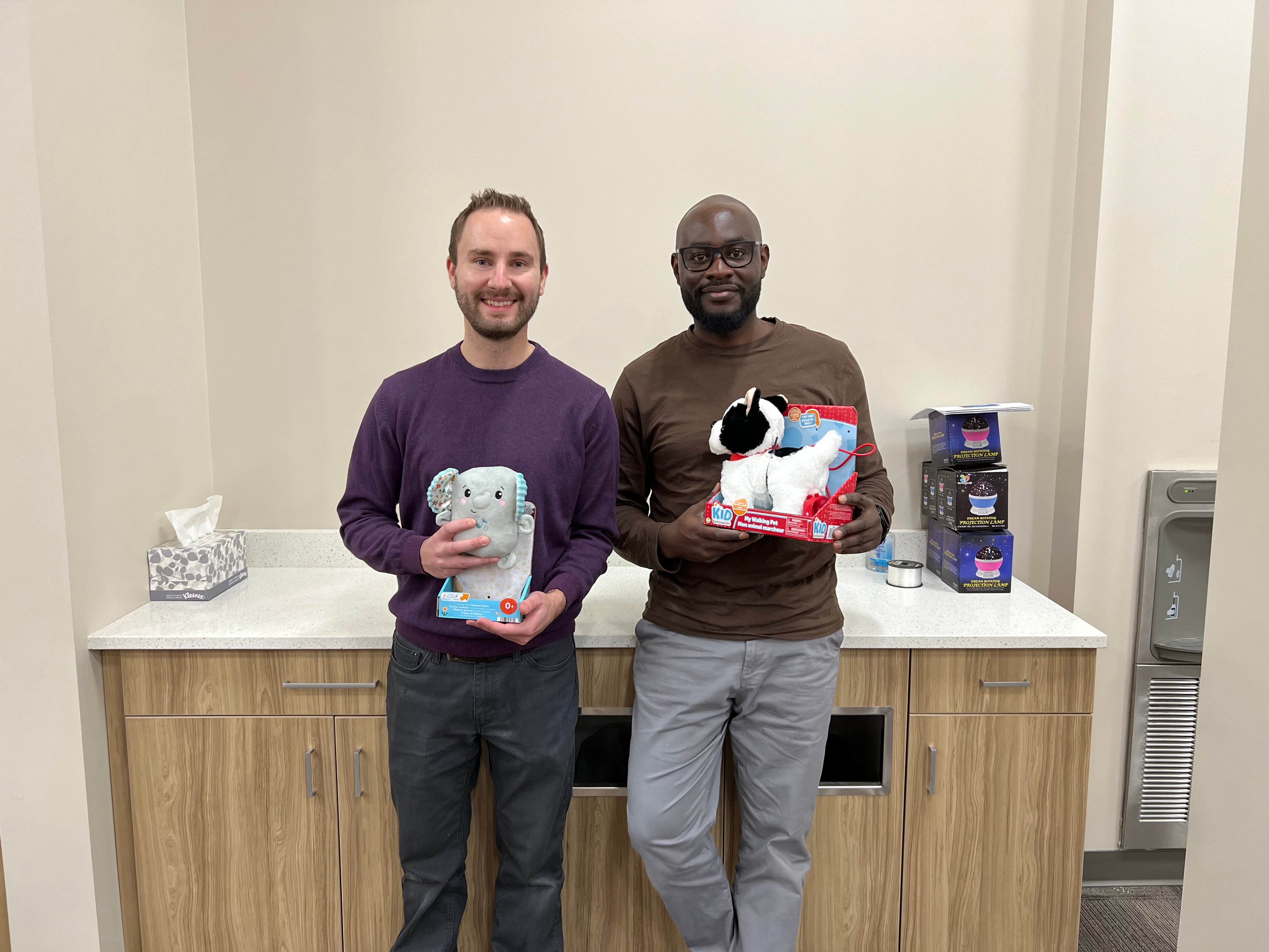wo SaskPower employees with adapted toys