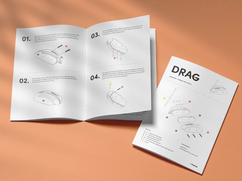 Instruction booklets printed on white paper sitting on a peach colored background.