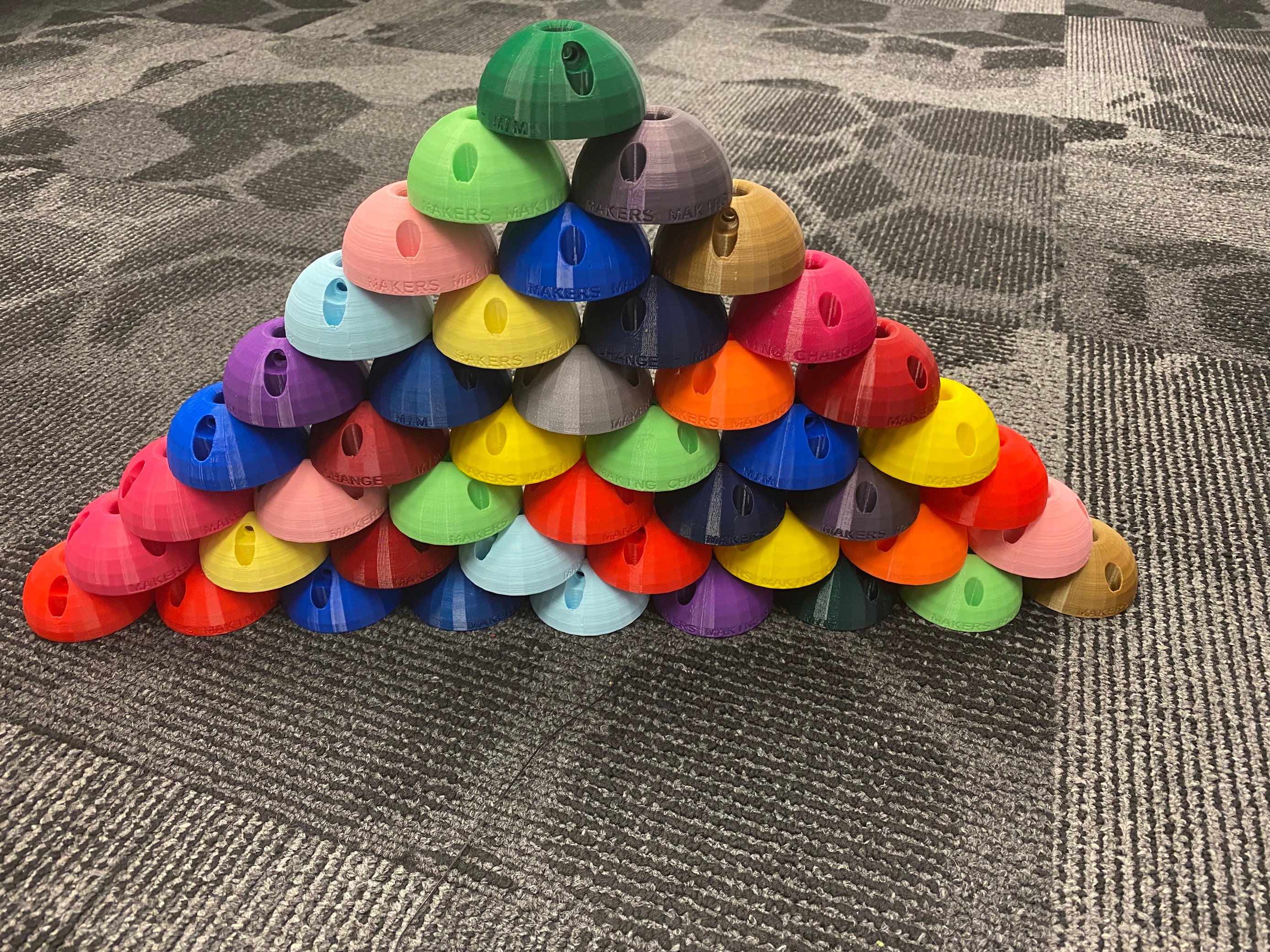 Different coloured 3d printed pen ball prints stacked on each other.