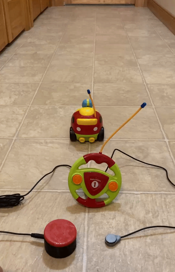 Animation of switch-adapted RC car in use. Two switches are plugged into the remote and pressed to control the car.