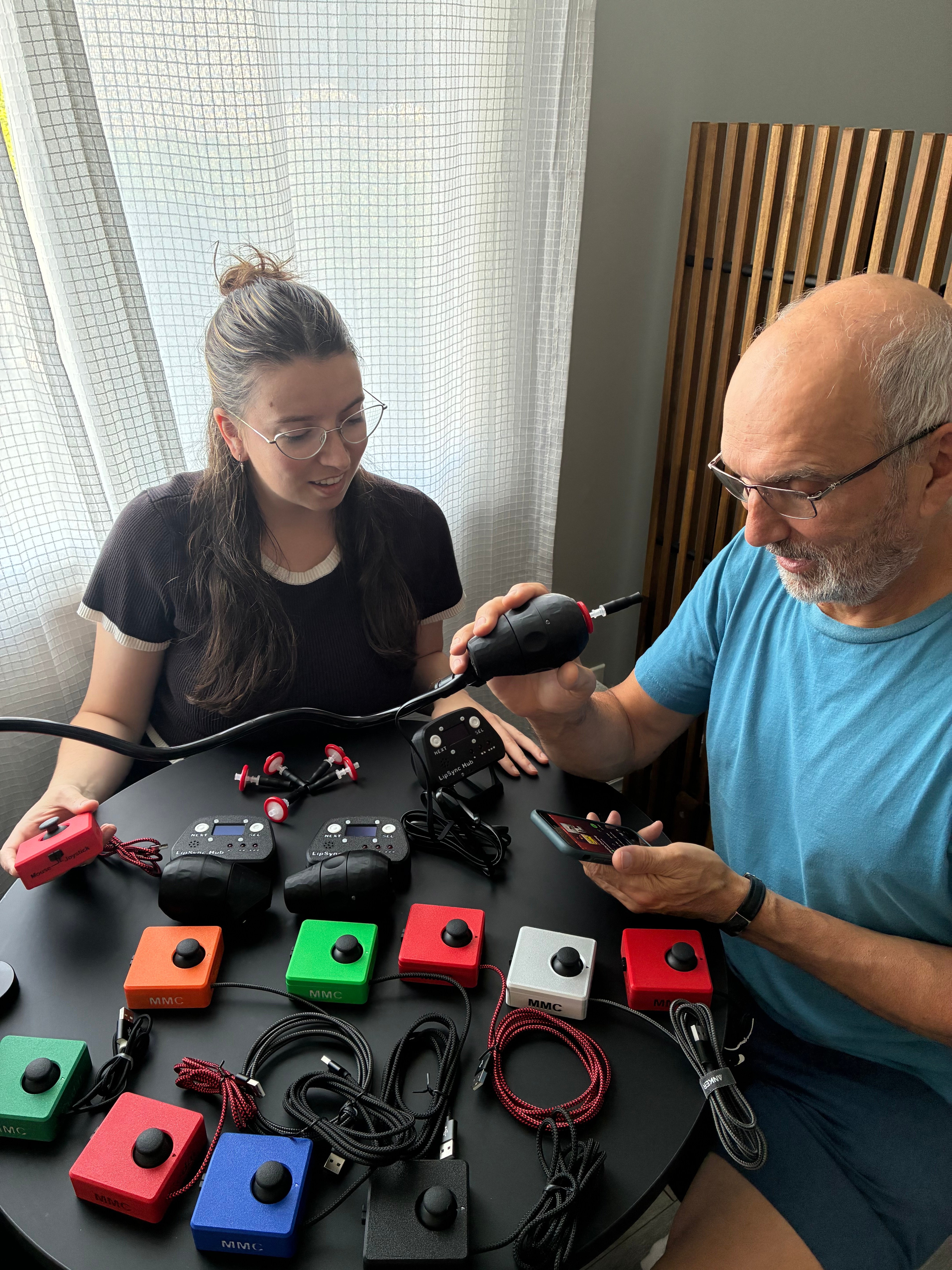 Alyssa and Jody testing the devices they've built, including many Cedar joysticks and a LipSync.
