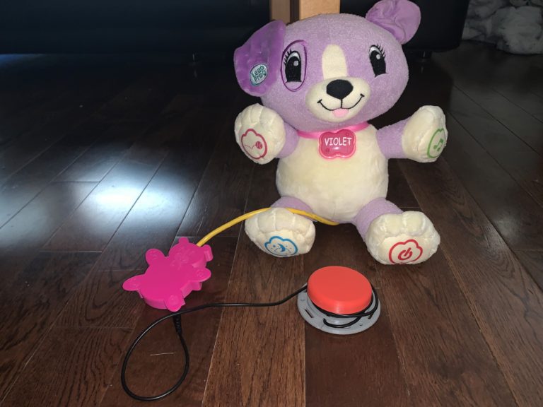 A switch-adapted purple toy connected to a red Interact Switch.
