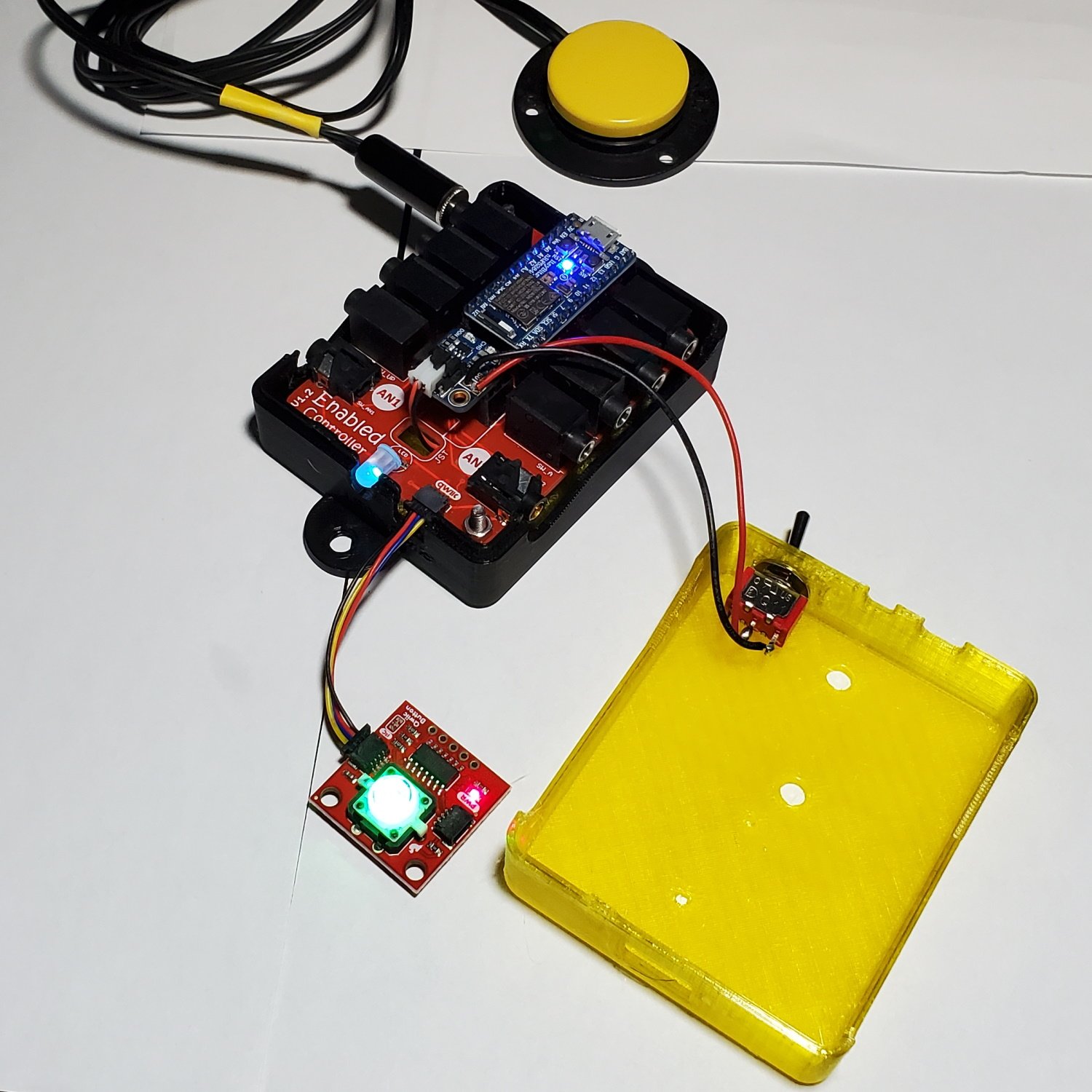 Interior view of an uncovered enabled controller with wires and PCBs exposed.