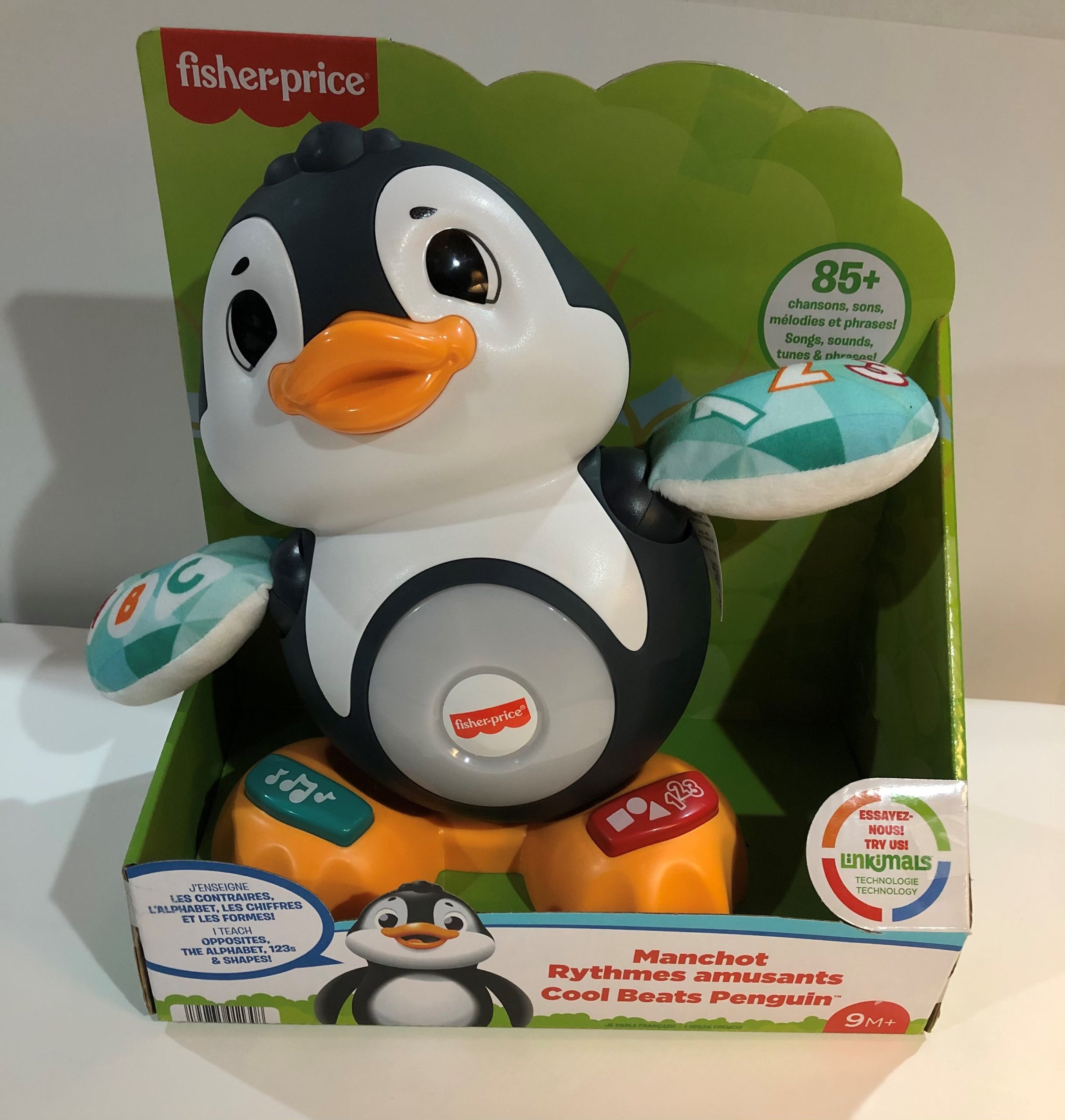 A Fisher Price switch-adapted penguin toy in its original packaging.