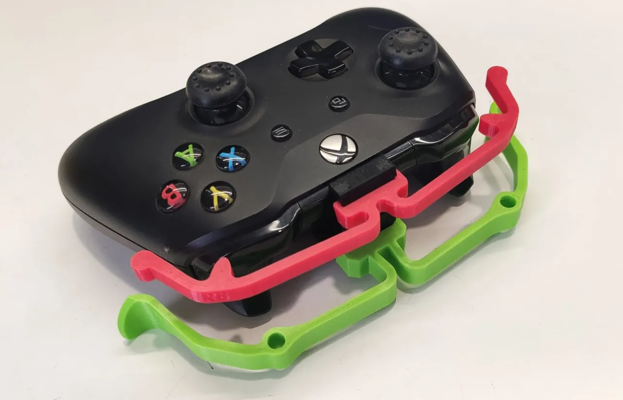 Back view of a black Xbox One controller with 3d printed extenders attached.
