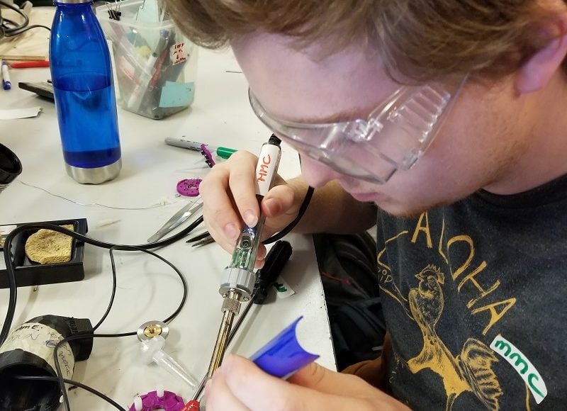 An MMC volunteer soldering.