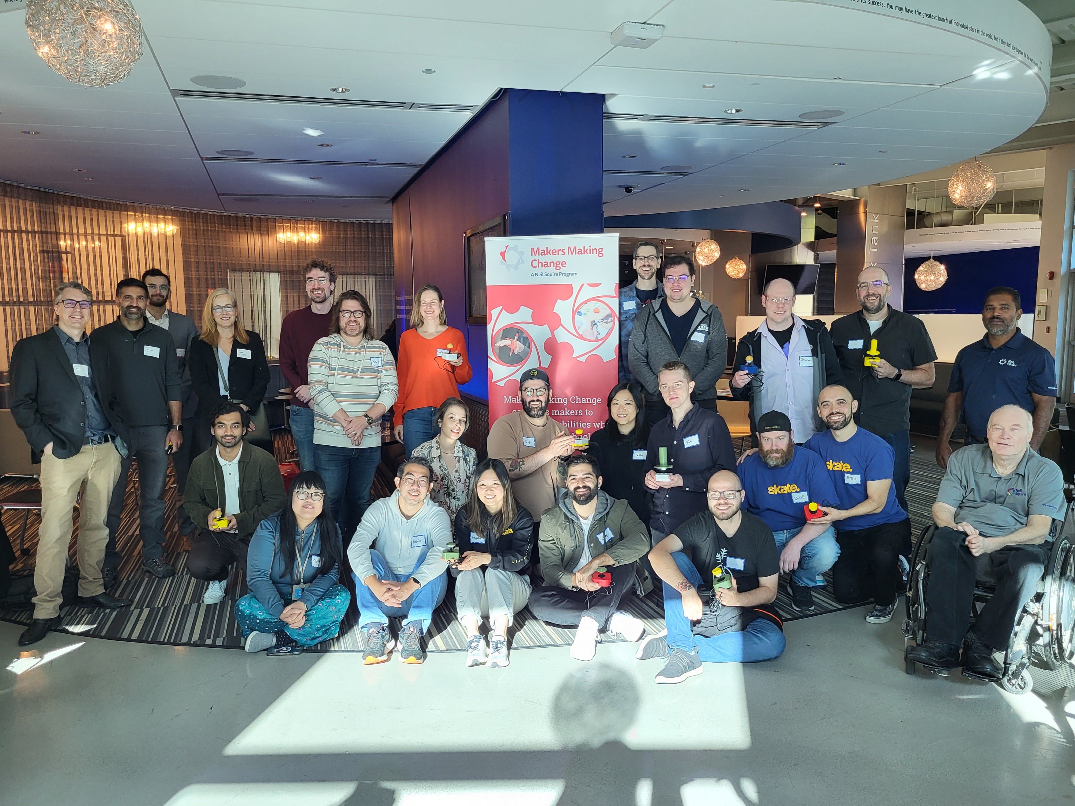 A group of EA employees posing with their built joysticks.