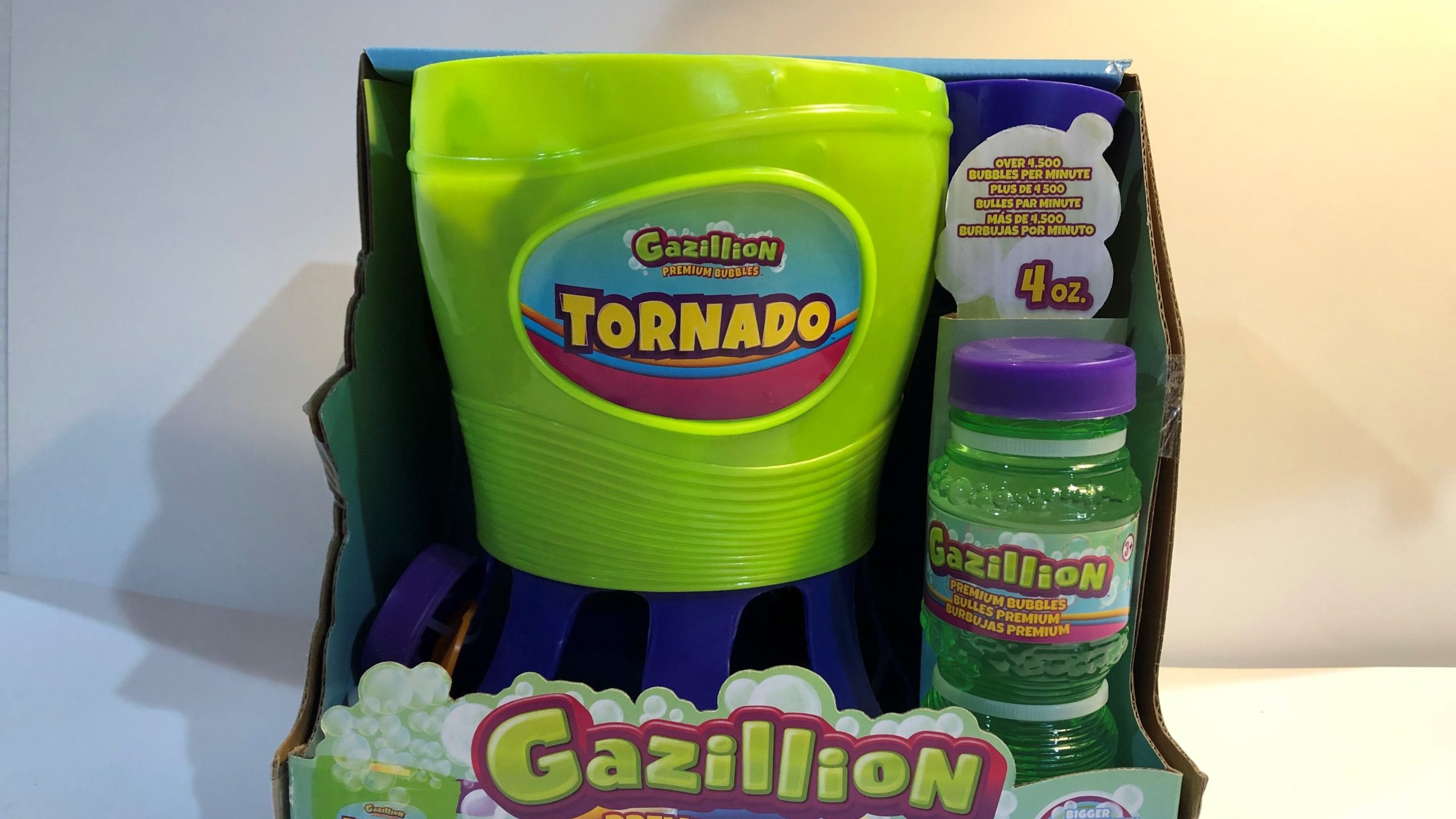 A green and purple switch-adpated bubbe blower in its original package.
