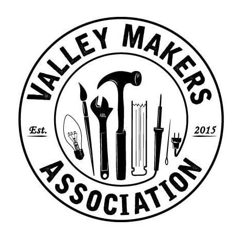A black and white logo for the Valley Makers Association with an image of tools in the centre of the circular logo.