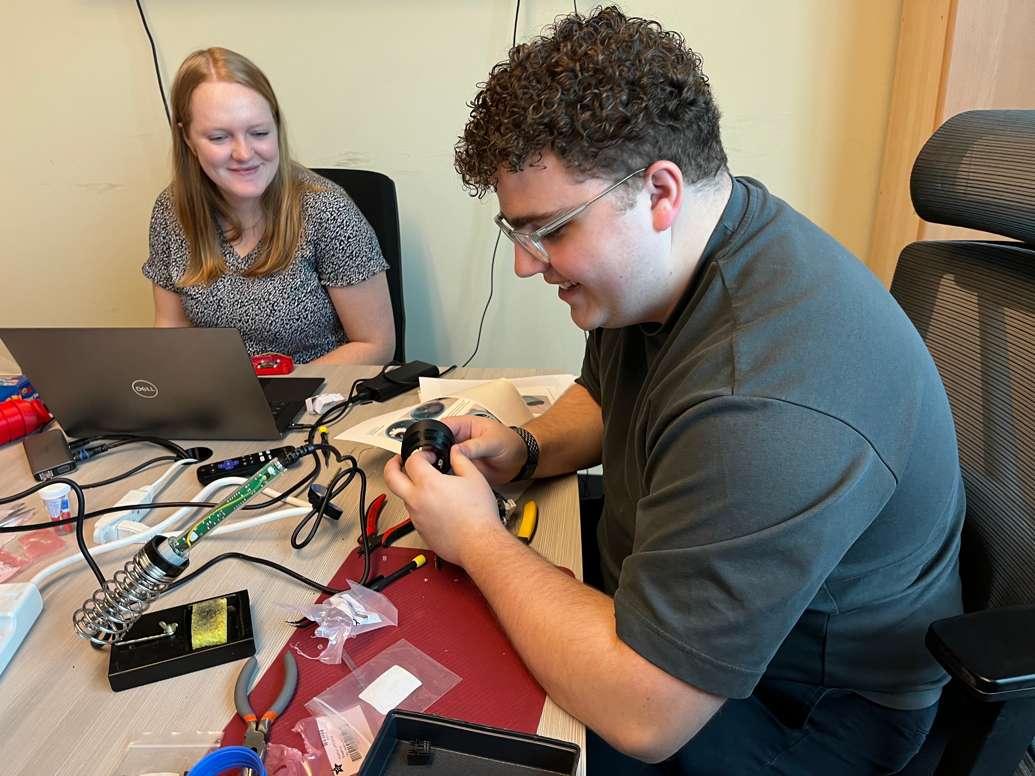 Makers Making Change staff building the Lipsync sip and puff device.