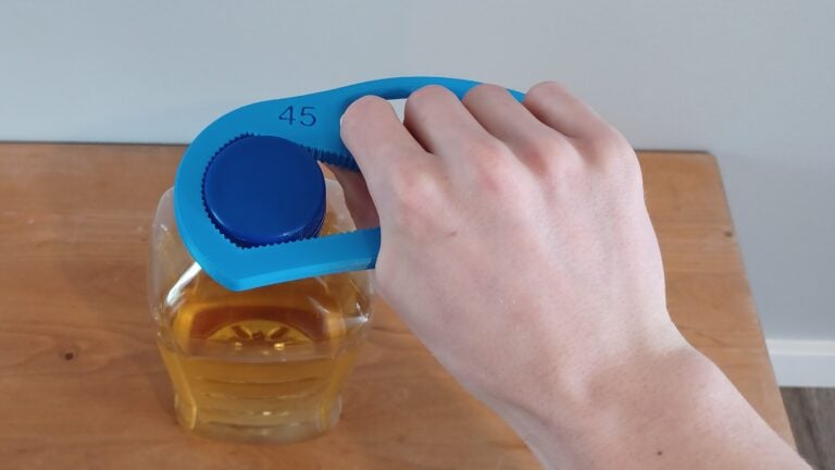 A blue Bottle Opener device opening a carton of juice.