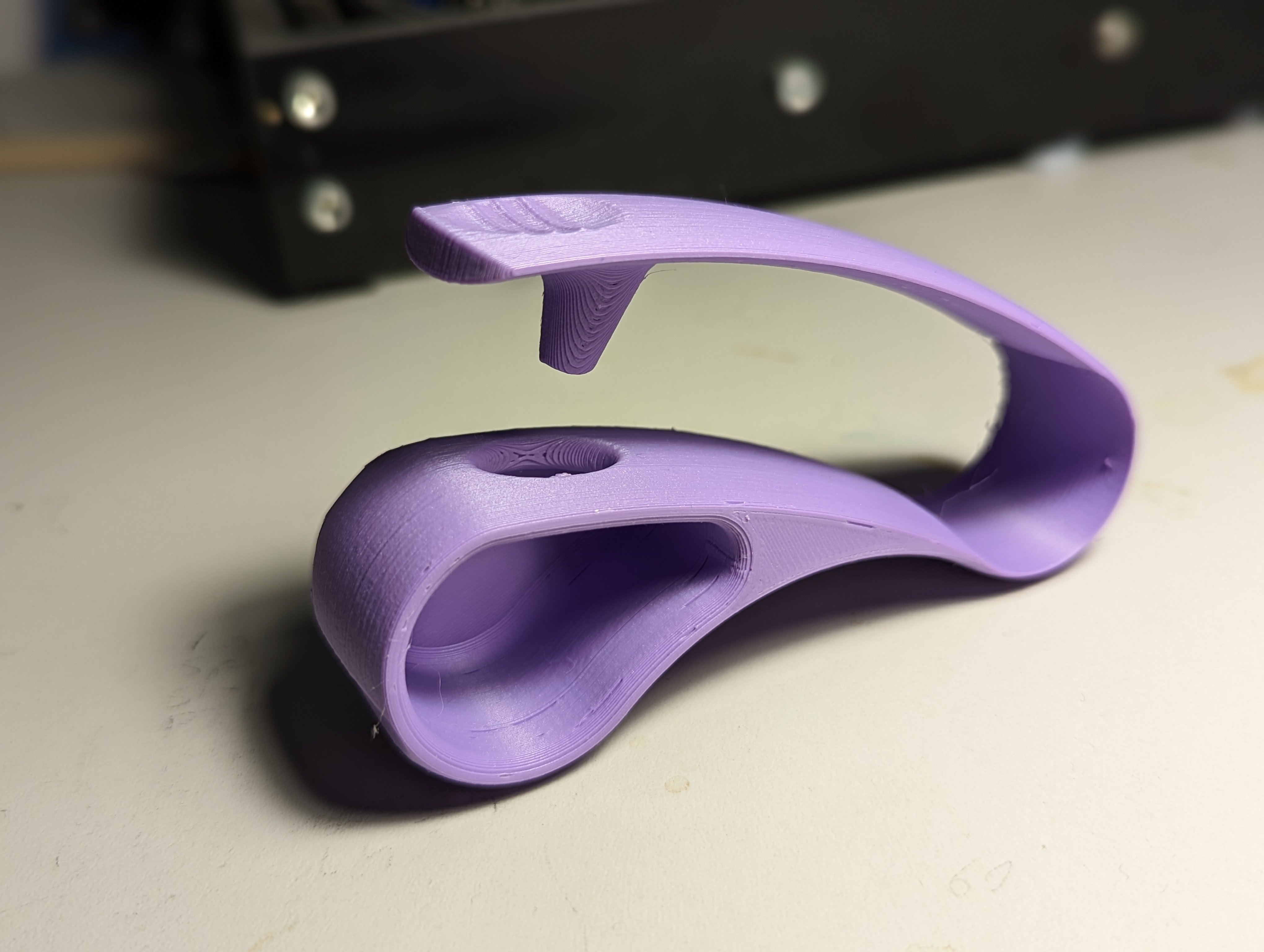 Blister pack opener printed in purple and sitting on a white table