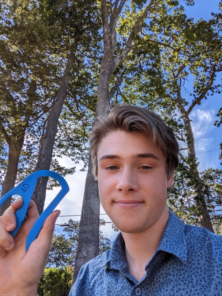 Taz, MMC intern, holding a blue Bottle Opener.