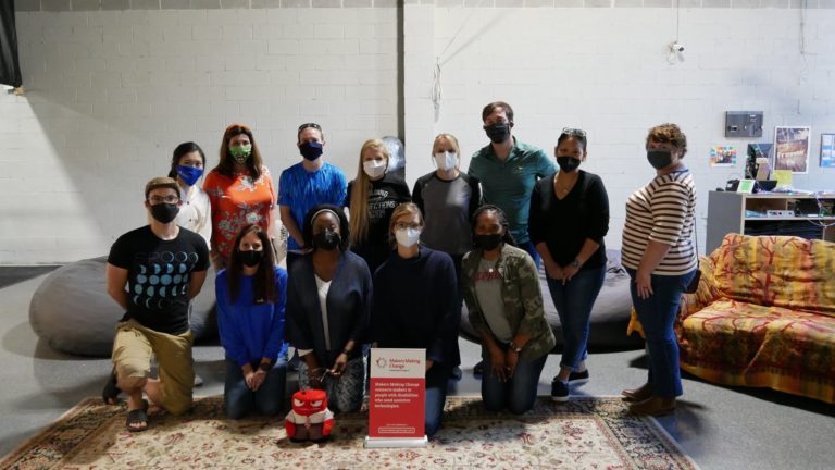Atlanta-based MMC volunteers gathered around a Makers Making Change sign.