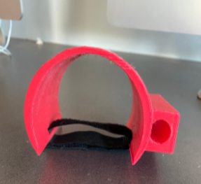 A c-shaped 3d printed drum holder with velcro loop.